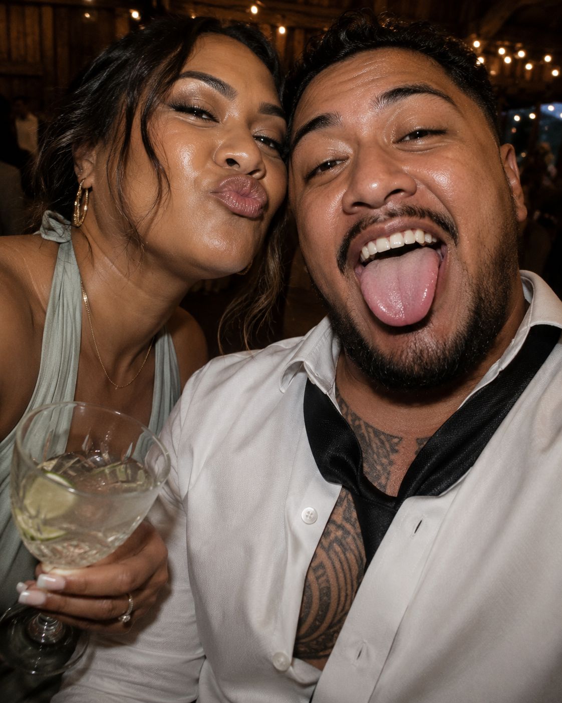 Two wedding guests pulling faces in a fun candid selfie