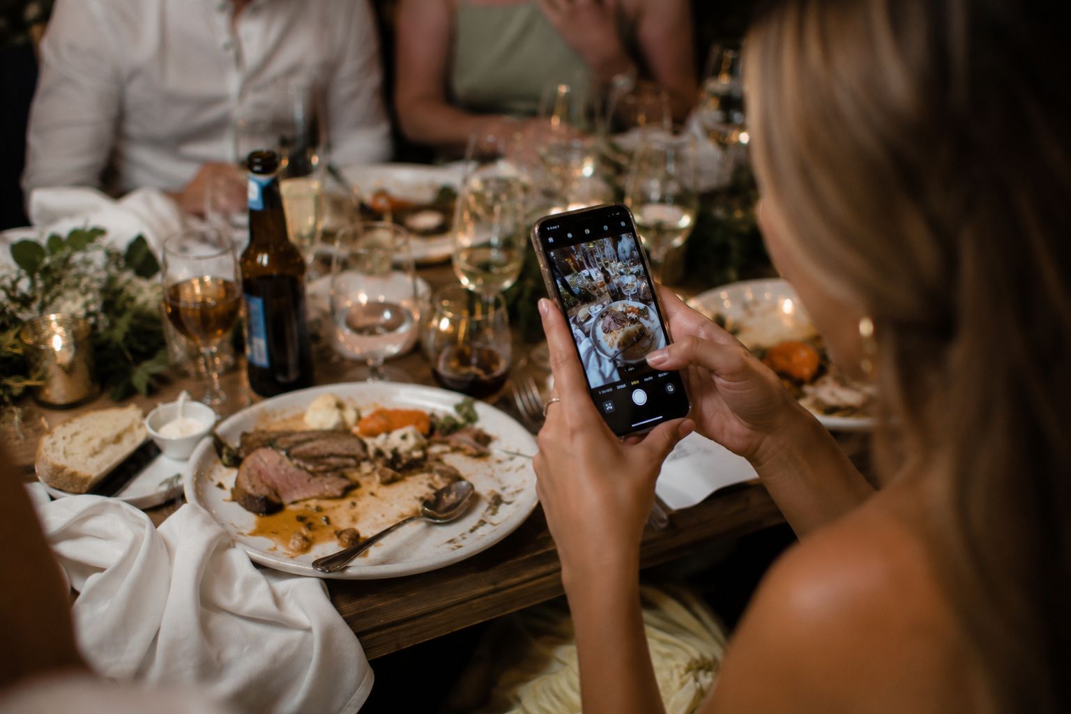 A guest photographing the moment on her phone