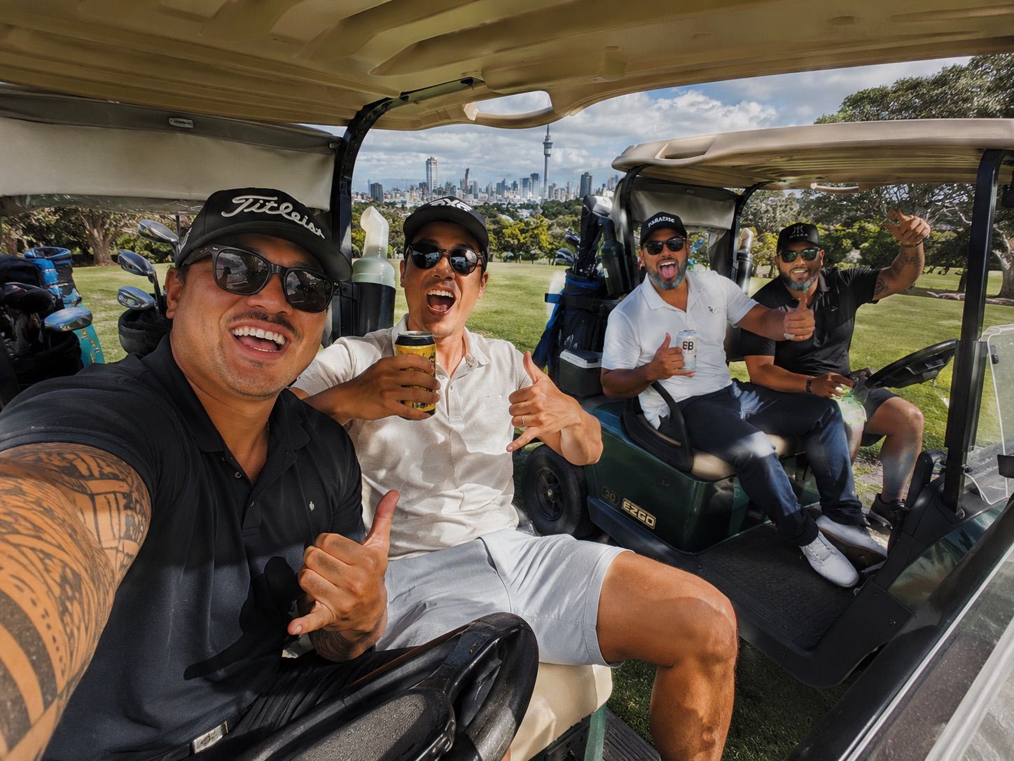 A stag party group on a golf cart with the city skyline behind